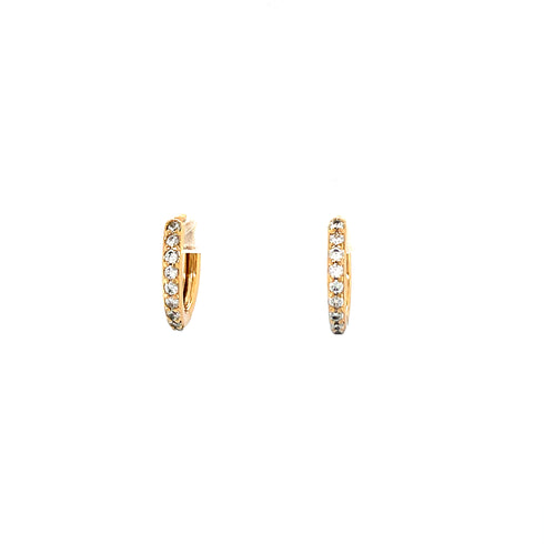 A pair of chic rose gold huggie-style earrings adorned with small, dazzling zirconia stones. Set against a plain white background, these radiant pieces beautifully showcase their brilliance and sophisticated design.